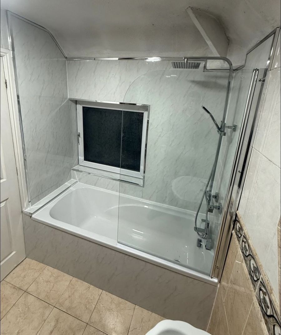 Bathroom after the work — new bath with glass shower screen fitted