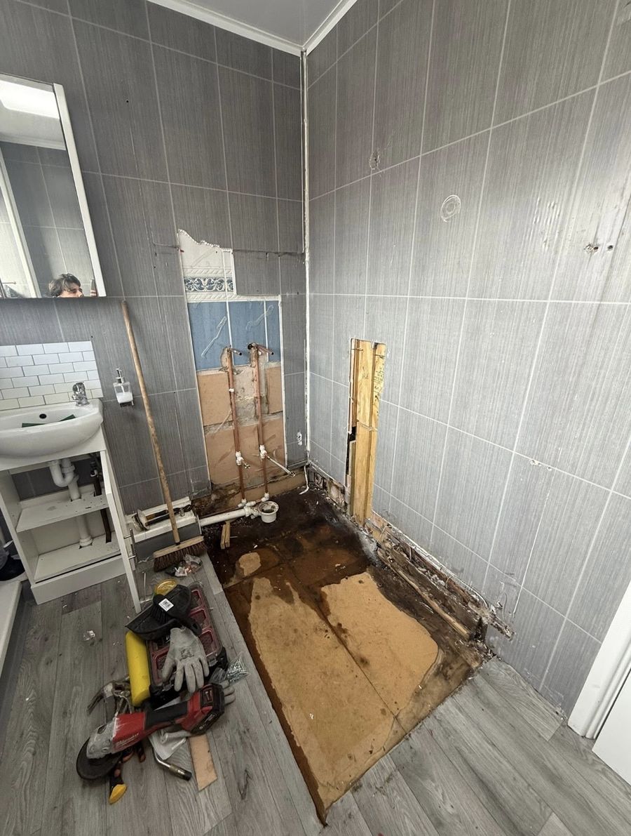Bathroom before the work — old suite stripped out ready for renovation